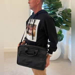 Authentic Tumi T Pass cross body laptop bag. Black. Removable strap.